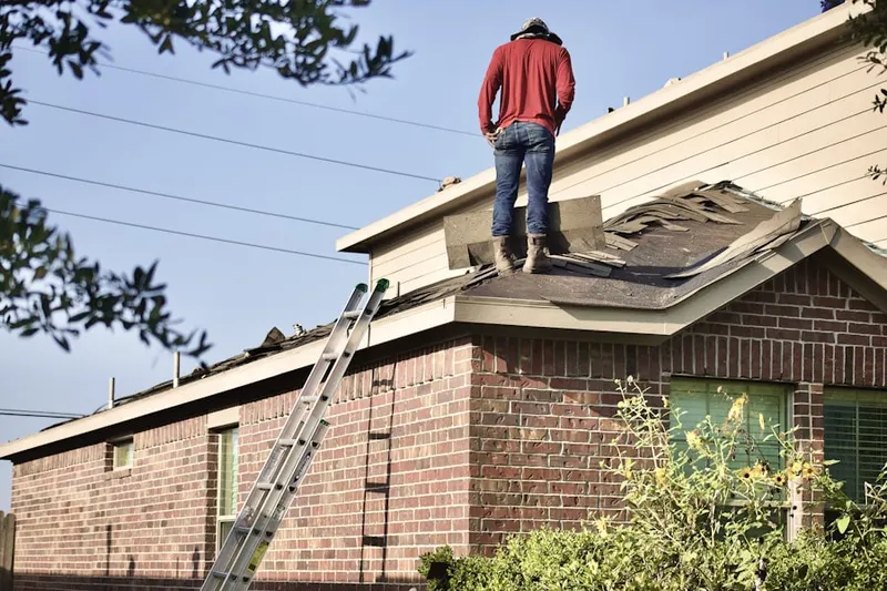 Professional roofer working on a residential roof in Willernie